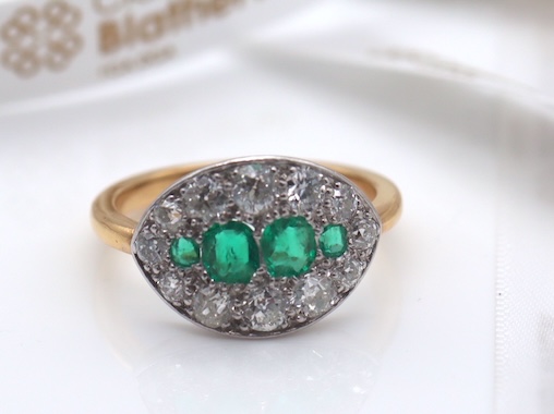 An Antique Early 20th Century Emerald and Diamond Cluster Ring